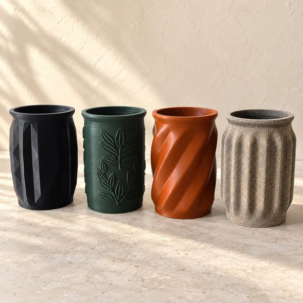 Four Glenn3D mason jar sleeves in black, green, terracotta, and neutral finishes